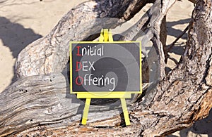 IDO initial DEX offering symbol. Concept words IDO initial DEX offering on beautiful yellow blackboard. Beautiful old tree