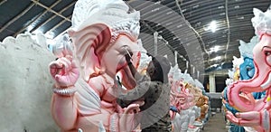 A idol maker is giving the final touch for Vinayaka or Ganesha idol in the occasion of Vinayaka or Ganesha Chaturthi.