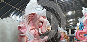 A idol maker is giving the final touch for Vinayaka or Ganesha idol in the occasion of Vinayaka or Ganesha Chaturthi.