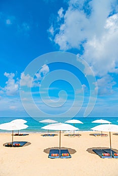 Idollic beach relaxing concept with white parasols on sand