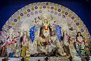 Idols of Hindu Goddess Maa Durga with her childrens in a pandal beautifully decorated during the Durga Puja festival