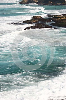 Idyllic and amazing seaside landscape of jagged coast with rocks and rushing white ocean waves