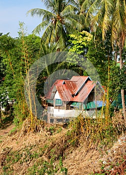 Idyllic ancient Laotian bungalow in the jungle, Laos