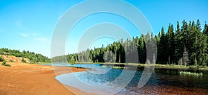 Idyllic Blue lake and forest landscape in evening sunset sunlight. Foy, Foyross Lake, Sudbury, Ontario, Canada.