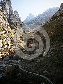 Idyllic cabin mountain hut along valley hiking trail path route Senda del Cares in Picos de Europa Leon Asturias Spain photo