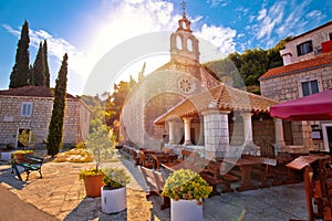 Idyllic coastal village of Racisce on Korcula island stone chapel sun haze view