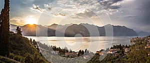 Idyllic coastline in Italy: Blue water and a cute village at lago di garda, Malcesine, sunset