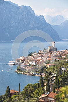 Idyllic coastline scenery in Italy: Blue water and a cute village at lago di garda, Malcesine