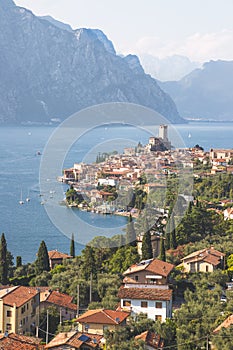 Idyllic coastline scenery in Italy: Blue water and a cute village at lago di garda, Malcesine