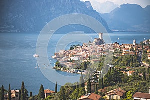 Idyllic coastline scenery in Italy: Blue water and a cute village at lago di garda, Malcesine