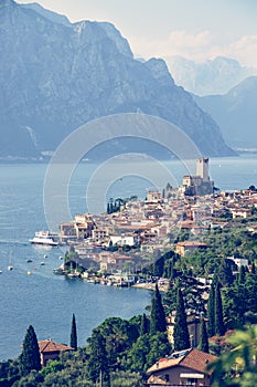 Idyllic coastline scenery in Italy: Blue water and a cute village at lago di garda, Malcesine