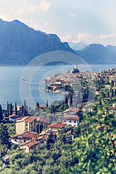 Idyllic coastline scenery in Italy: Blue water and a cute village at lago di garda, Malcesine