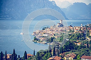 Idyllic coastline scenery in Italy: Blue water and a cute village at lago di garda, Malcesine