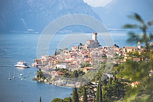 Idyllic coastline scenery in Italy: Blue water and a cute village at lago di garda, Malcesine