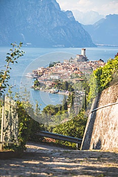 Idyllic coastline scenery in Italy: Blue water and a cute village at lago di garda, Malcesine