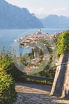 Idyllic coastline scenery in Italy: Blue water and a cute village at lago di garda, Malcesine