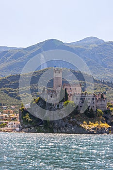 Idyllic coastline scenery in Italy, captured from the water. Blue water and a cute village at lago di garda, Malcesine