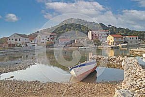 Idyllic Dalmatian landscape, island Vrgada near Zadar, Croatia, traditional houses and an old wooden boat, Adriatic sea