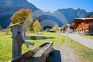 Idyllic destination with wooden standpipe and alpine huts, Engalmen, karwendel valley