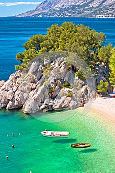 Idyllic emerald beach and boats in Brela aerial vertical view