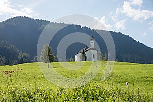 Idyllic green hilly landscape near achenkirch, with pilgrimage chapel and green pasture