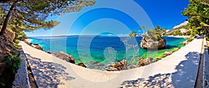 Idyllic islet on Punta Rata beach in Brela panoramic view photo