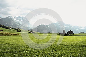 Idyllic isolated farm buildings in pictureque Alpstein Appenzell mountain hills landscape Innerrhoden Switzerland