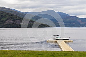 Idyllic lake front mooring. Small boat moored on a Loch