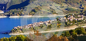 Idyllic lake scenery - Lago Turano and beautiful village Cole di Tora in Rieti province, Italy