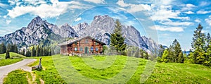 Idyllic landscape in the Alps with mountain chalet photo