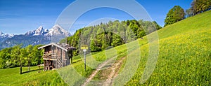 Idyllic landscape in the Alps with traditional mountain lodge in spring