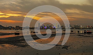 Idyllic landscape of Lau Fau Shan in Hong Kong and skyline of Shenzhen city in China under sunset