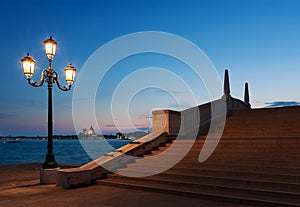 Idyllic landscape of street lamp, bridge and canal in Venice, Italy