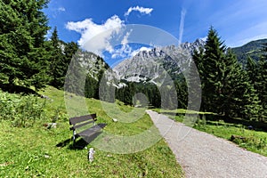 Idyllic mountain scene with a bench in the foreground. Austrian alps, Tyrol, Wilder Kaiser