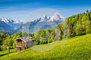 Idyllic mountain scenery with old chalet in the Alps in springtime
