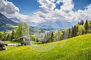 Idyllic mountain scenery with traditional mountain chalet in the Alps in springtime