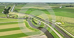 Idyllic old dutch historic traditional windmill aerial drone overhead overview. Historic typical dutch culture and