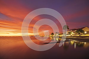 Idyllic orange sunrise on the beach of Los Urrutias, in the Mar Menor, Cartagena,