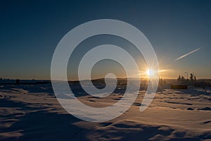 Idyllic panoramic cold winter view in the arctics with lot of snow and blue sky.