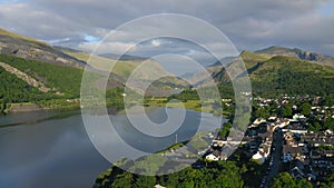 Idyllic, picturesque Llanberis town in Wales, with mountains landscape and forest scenery beside Pa