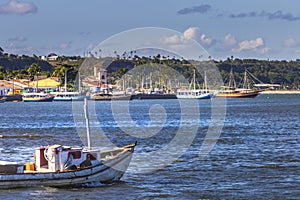 Idyllic Porto Seguro Beach with lonely fishermen trawler boat, BAHIA, Brazil