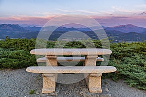 Idyllic rest place with stone bench and table