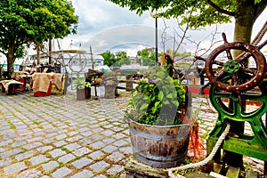 Idyllic river promenade with ships and fishermen decoration in Leer, Ostfriesland, Germany