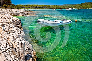 Idyllic rocky beach Sakarun and small boat on Dugi Otok island