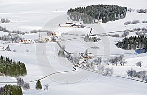 Lovely rural countryside on snowy winter day. Aerial view of barnyards and farm. Weitnau, Allgau, Bavaria, Germany. photo