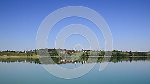 Idyllic rural landscape reflecting in Lake Pfaffikon