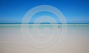 Idyllic seascape with people swimming in the water in Holbox, Quintana Roo, Mexico