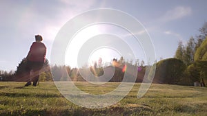 Idyllic shot of a middle aged lady walking in a park on a sunny day.