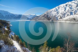 Idyllic snow landscape with mountain lake in the Alps