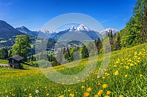 Idyllic springtime landscape in the Alps with traditional mountain lodges